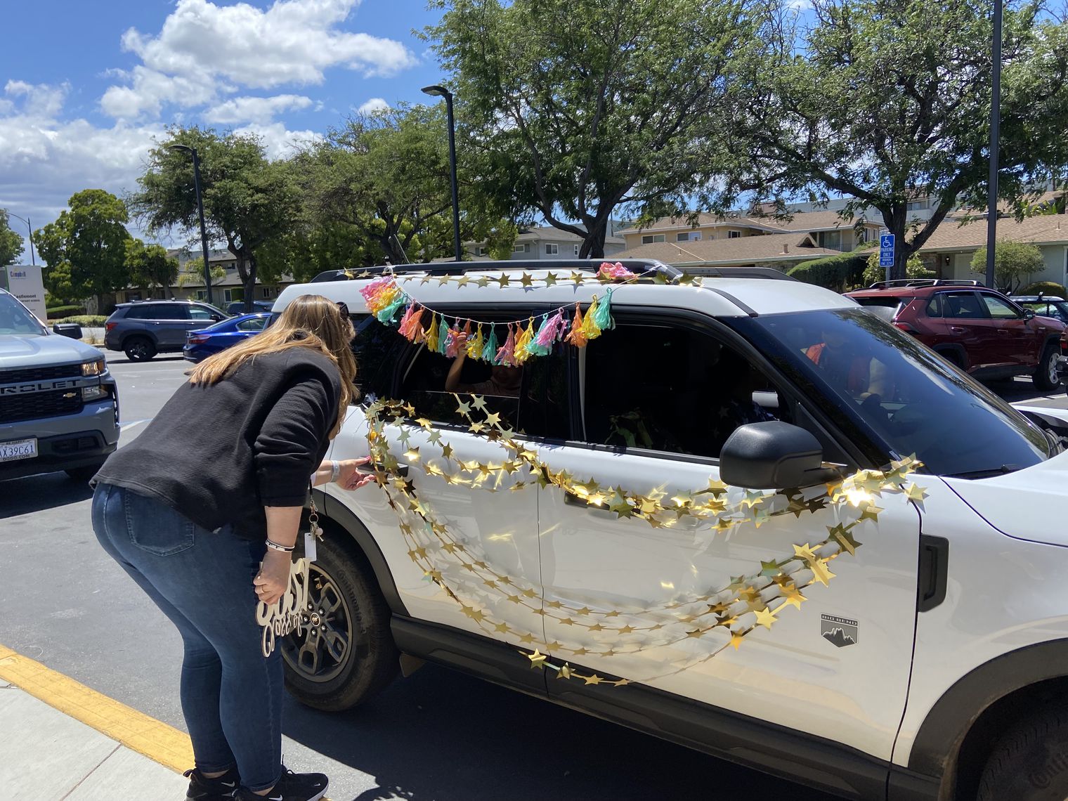 Teacher greets kindergarten family during promotion