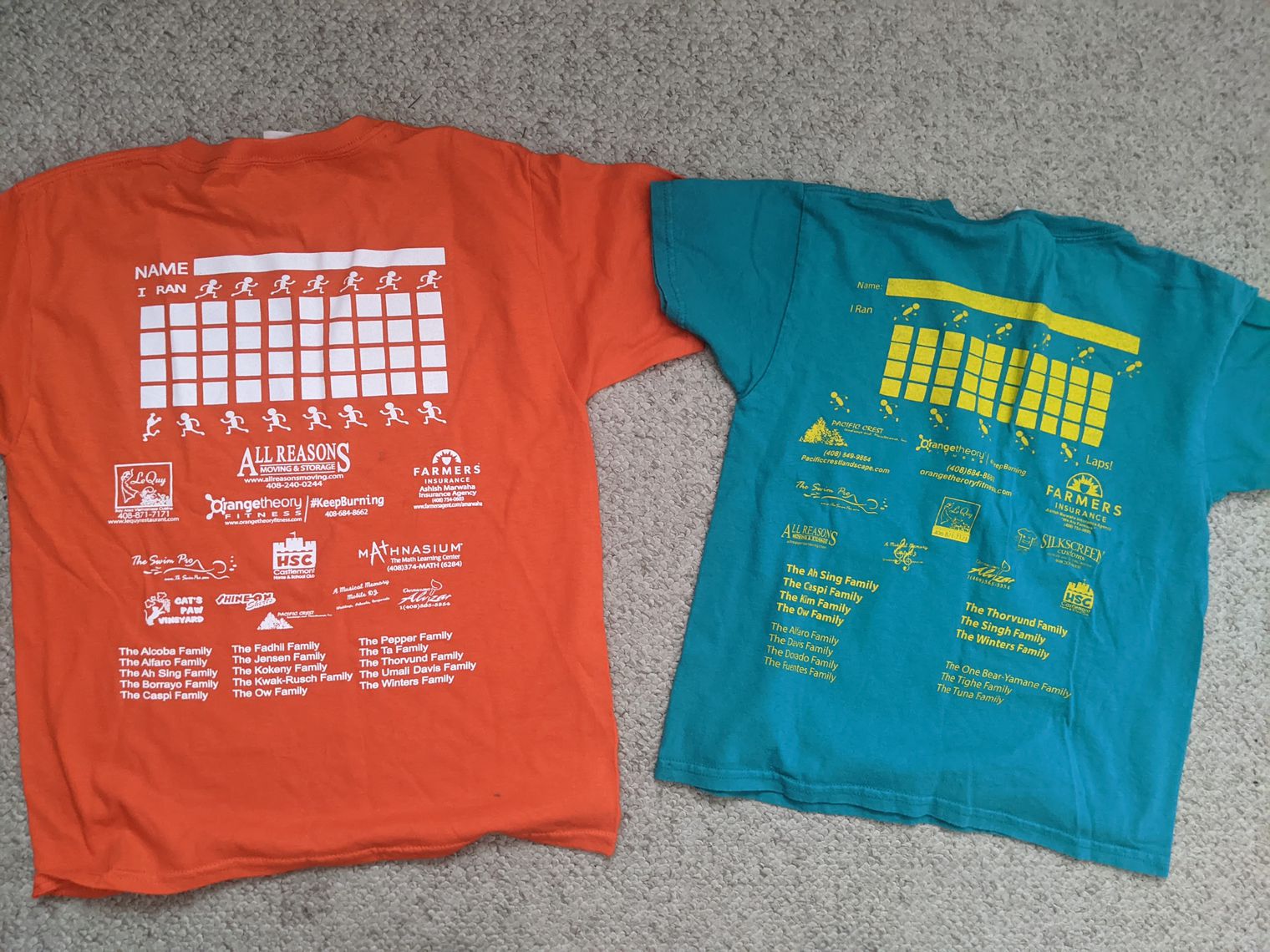 Two short-sleeve tshirts with writing on the back.
