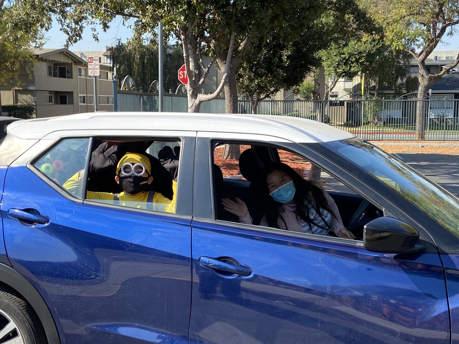 Mother and son in costume in a car at the parade.