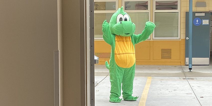 Dragon mascot waving