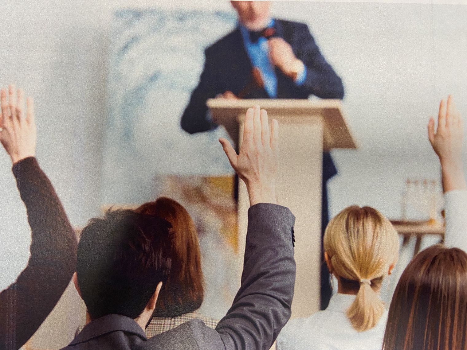 Auctioneer and raised hands bidding