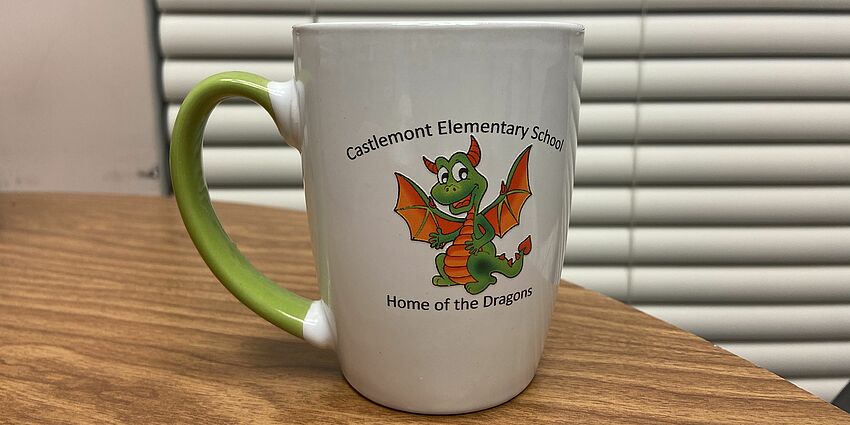 coffee mug with a cartoon dragon design