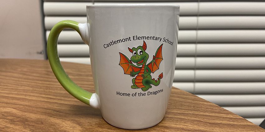 Coffee mug with dragon illustration on it.