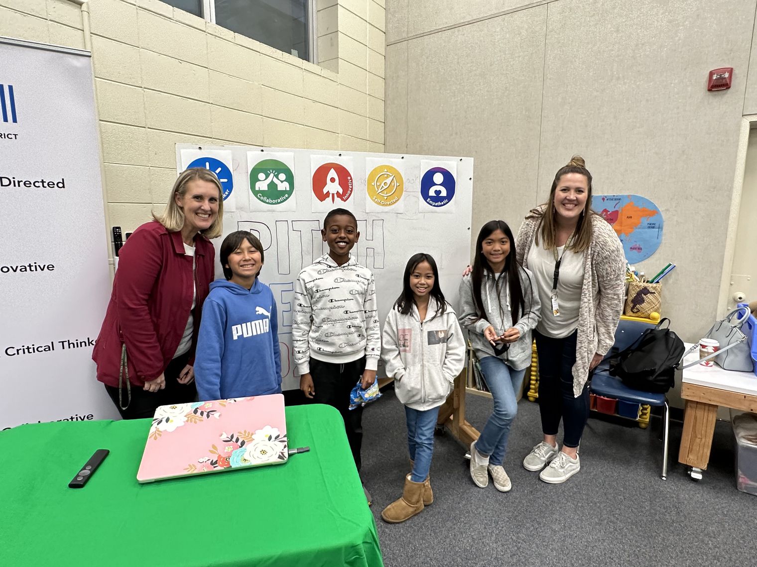 Two teachers and four students posing for photo