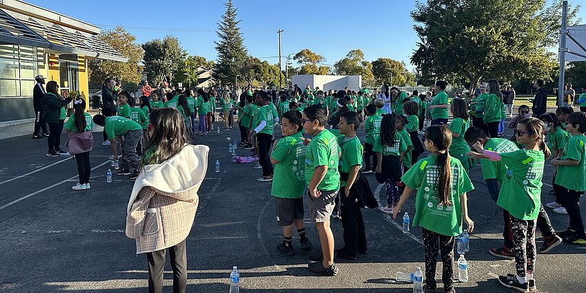 Children in green shirts exercising