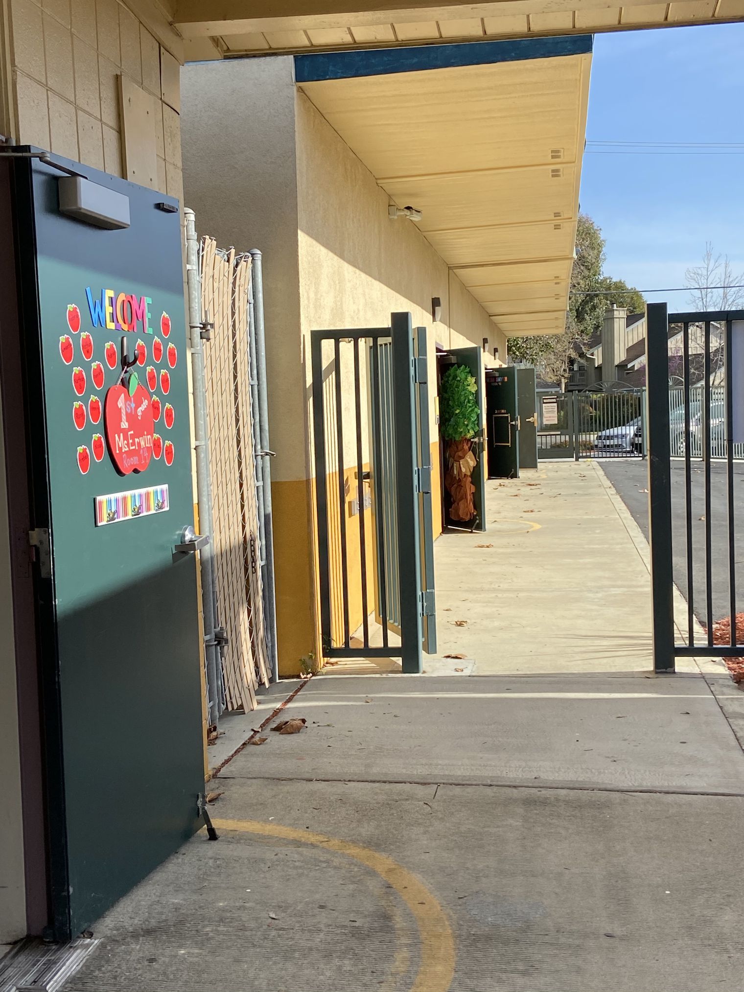 Open classroom doors into an outdoor hallway.