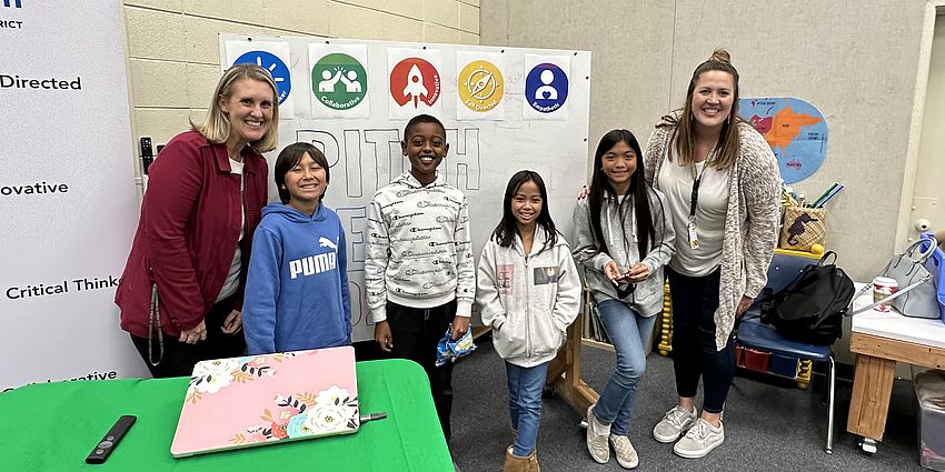 Two teachers and four students posing for photo