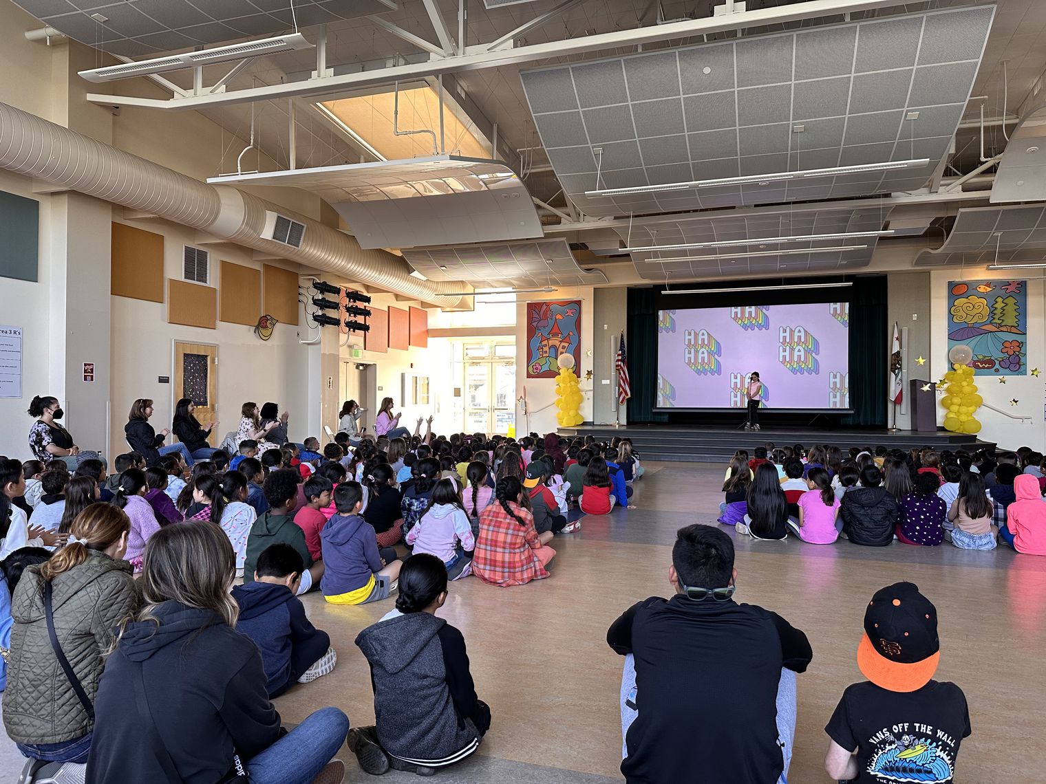 students watching a stage performance at school