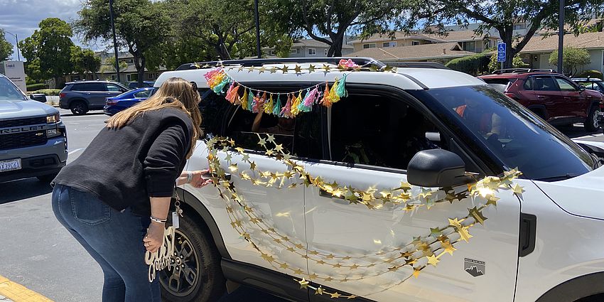 Teacher greets kindergarten family during promotion