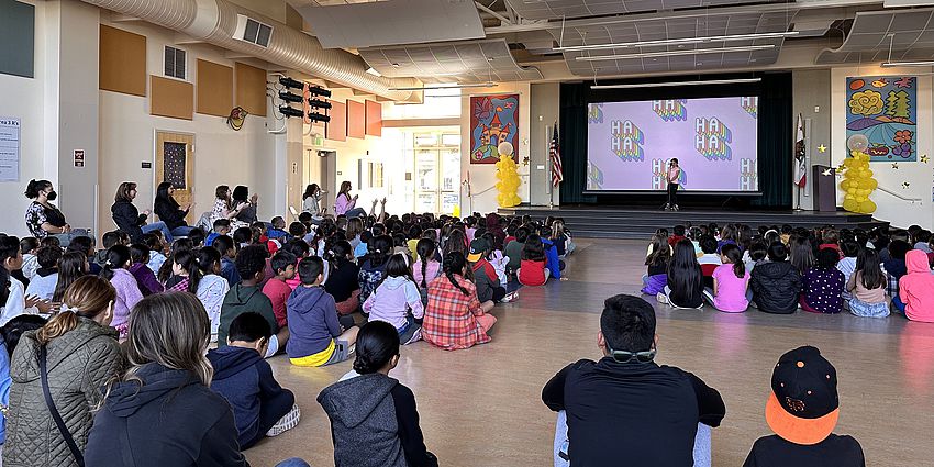 students watching a stage performance at school