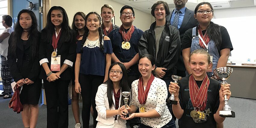 members of Monroe's Scholars Cup team at board meeting