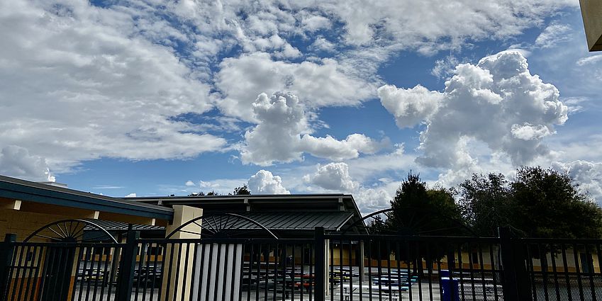 Cloud-filled blue sky over the Castlemont covered eating area.