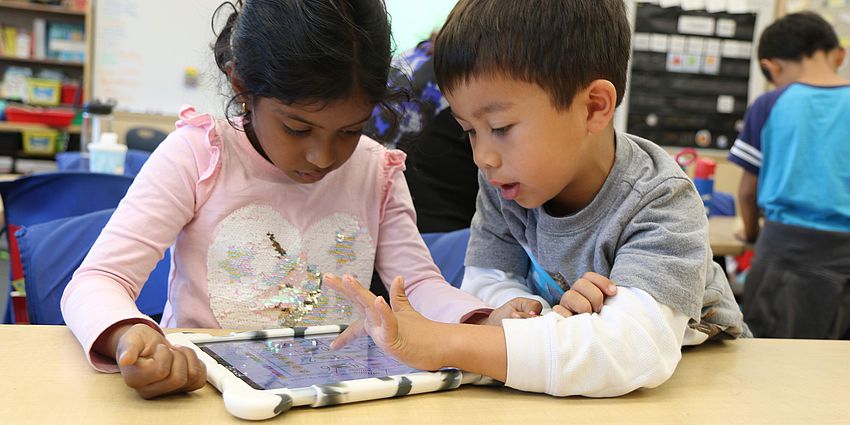 two young students with laptop