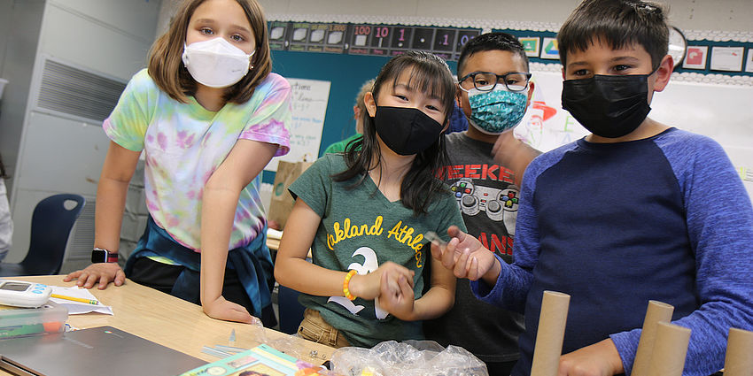 four students with a project