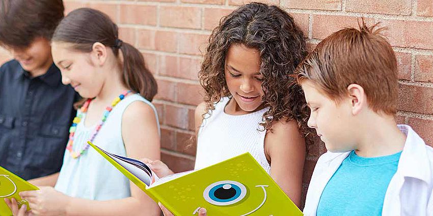 Children looking at yearbooks