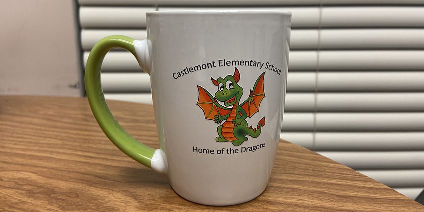 A Castlemont Elementary dragon coffee mug. 