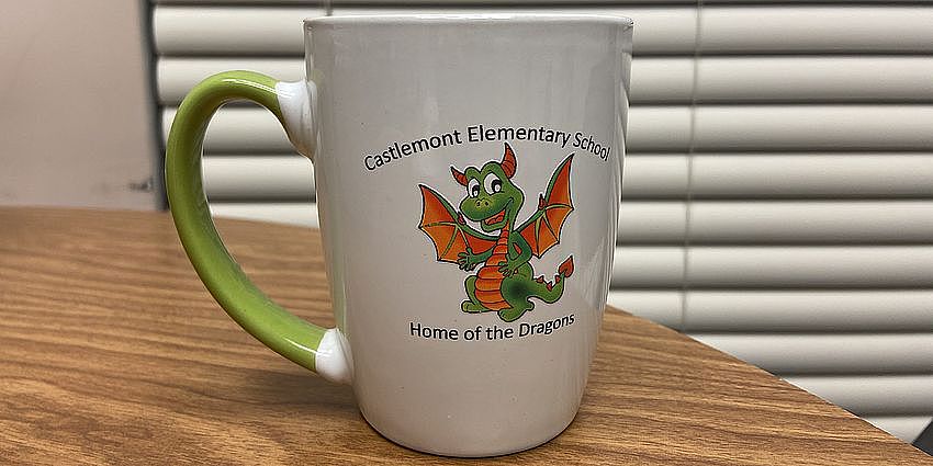 Coffee mug with dragon illustration on it.