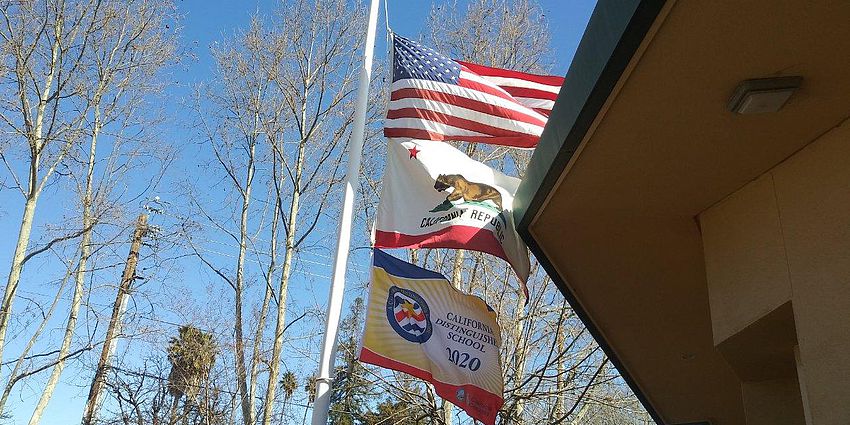 American flag, California Flag, and distinguished school flag