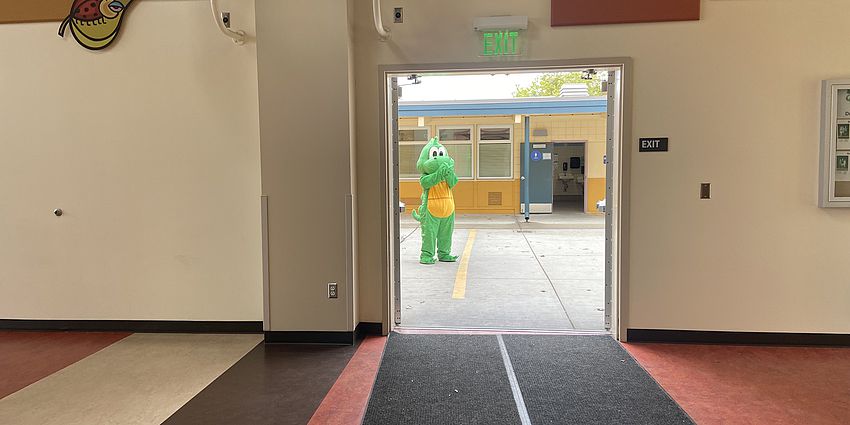 Dragon mascot in a doorway