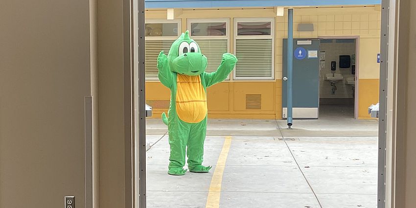 Dragon mascot in a doorway