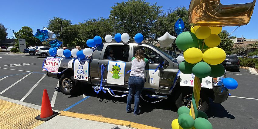 Truck with 5th grader and teacher celebrating promotion.