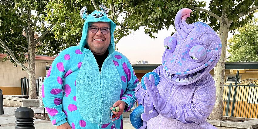 Two Monsters Inc costumed adults