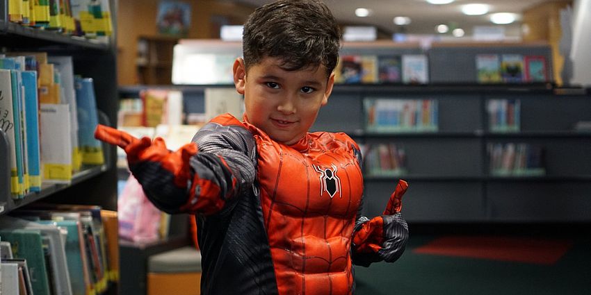 Child in costume at the library