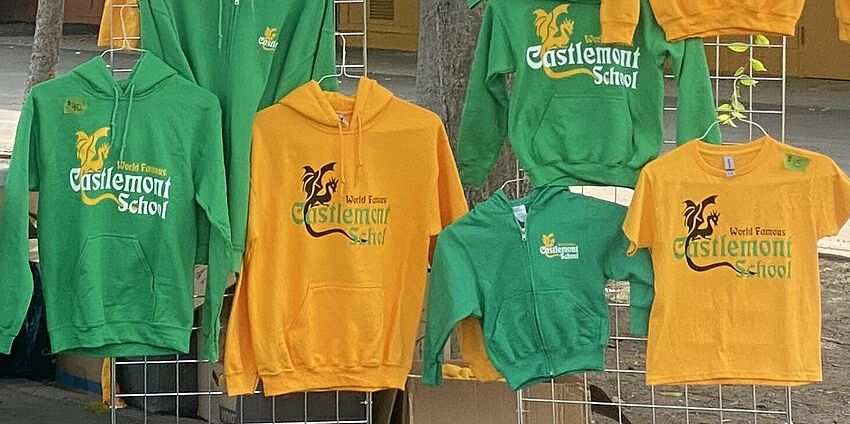 green and gold sweatshirts hanging on a display rack