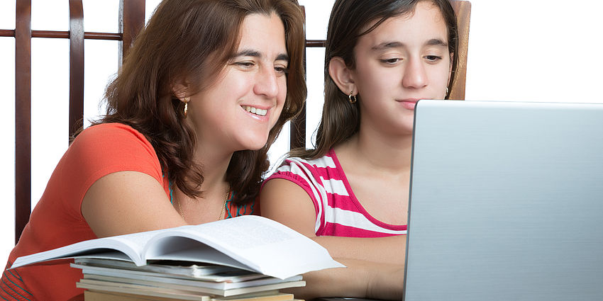 student doing homework with laptop