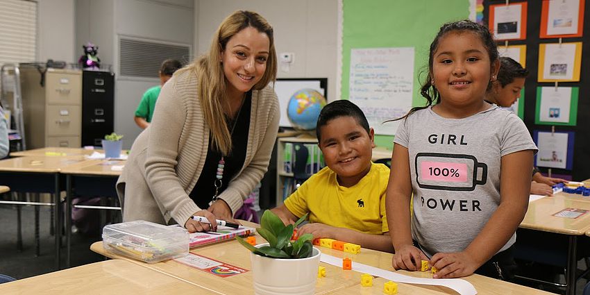 Child and teacher playing with math toys