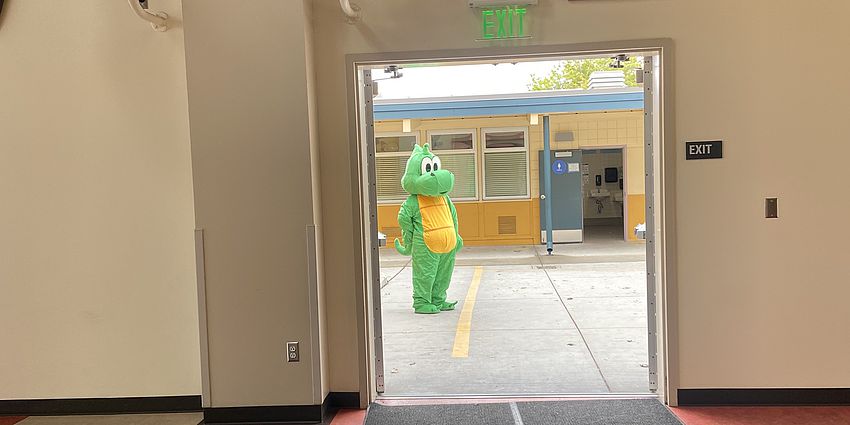 Dragon mascot seen through an open door