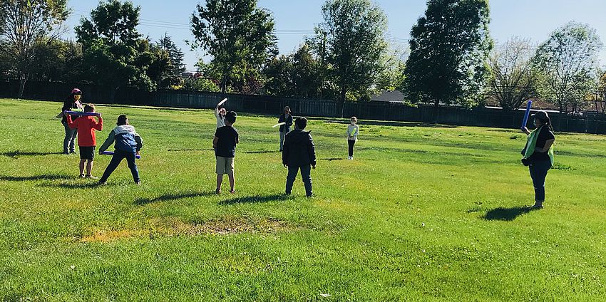 Students playing on the grass