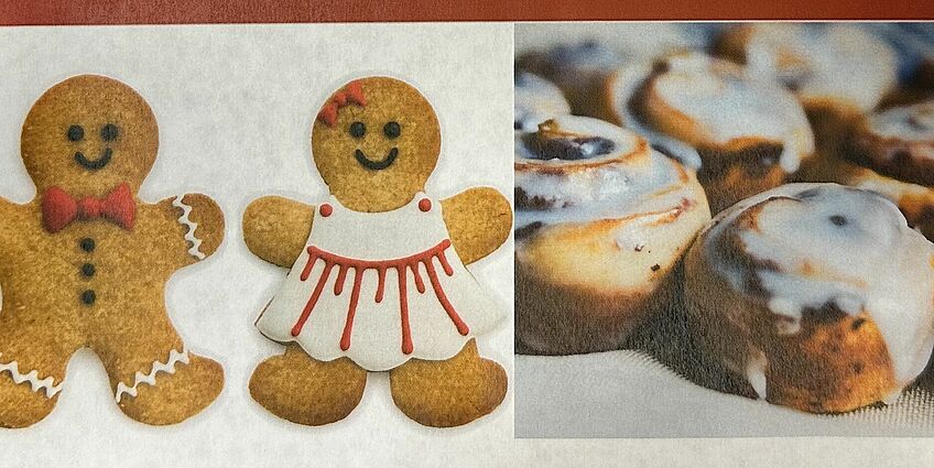 two gingerbread cookies and cinnamon rolls