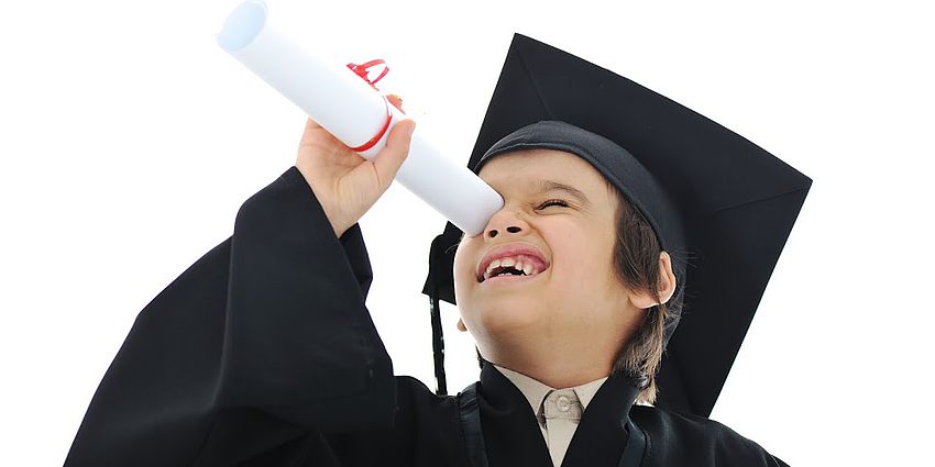 young boy in graduation cap and gown