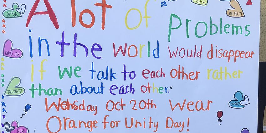 Hand lettered sign about Unity Day