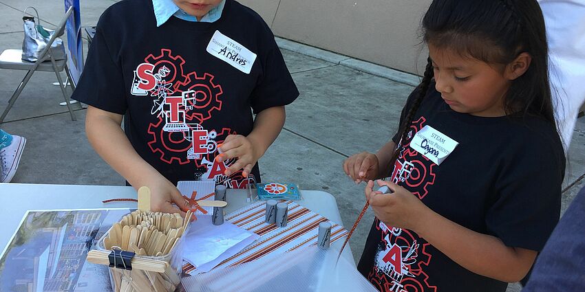 children working on a project requiring art, science and math