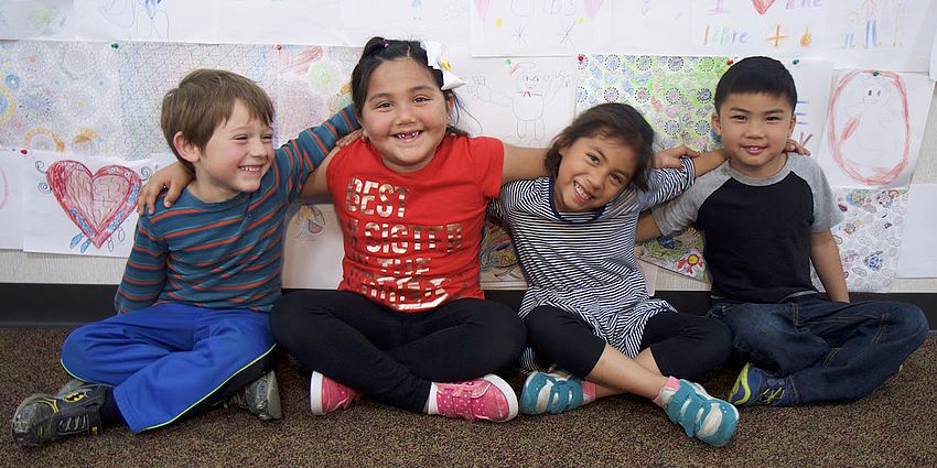 four smiling children