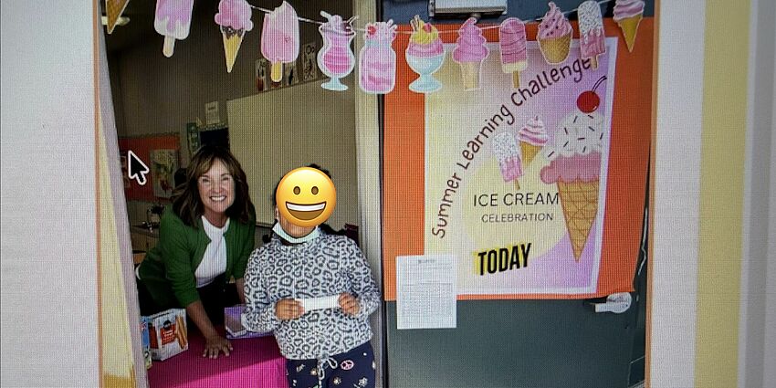 Two people in a  doorway next to an ice cream sign