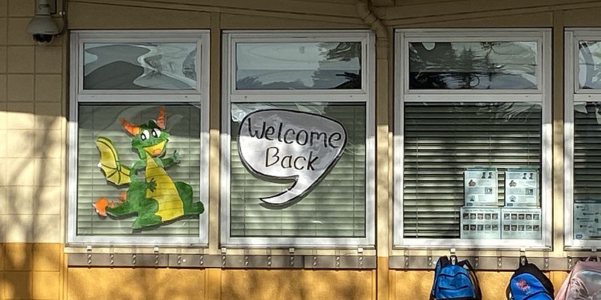 Classroom windows with dragon poster.