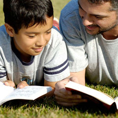 father and son reading together