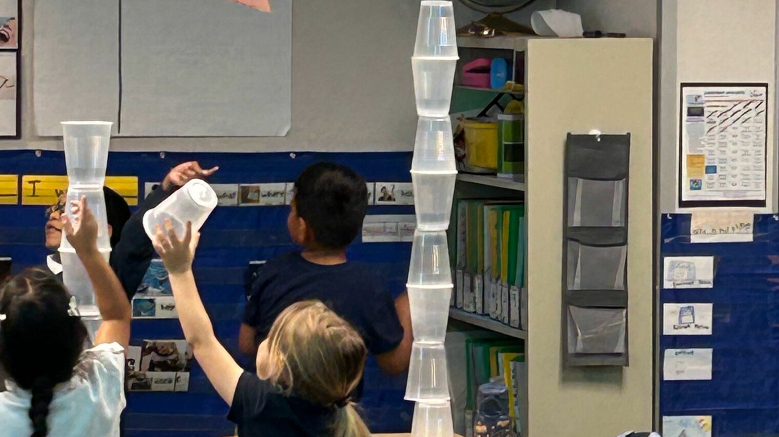 Students building with plastic cups