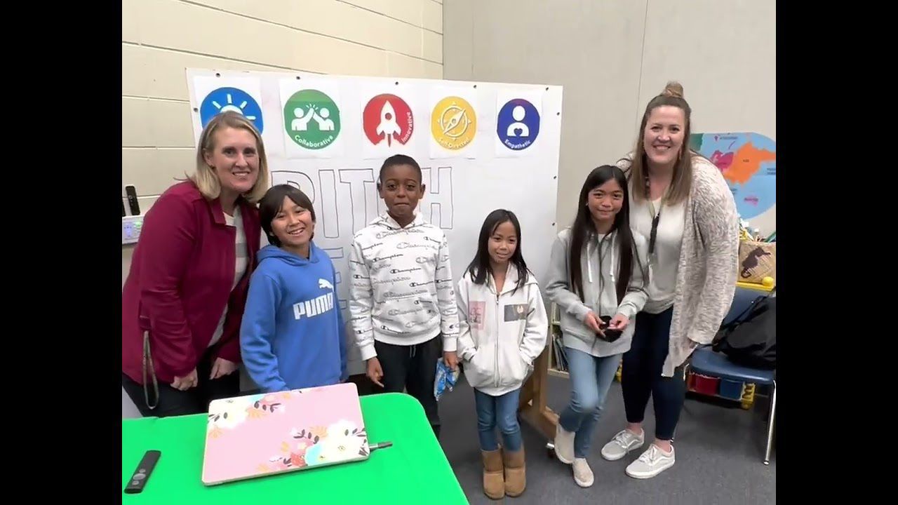 two women and four young students standing in line and smiling