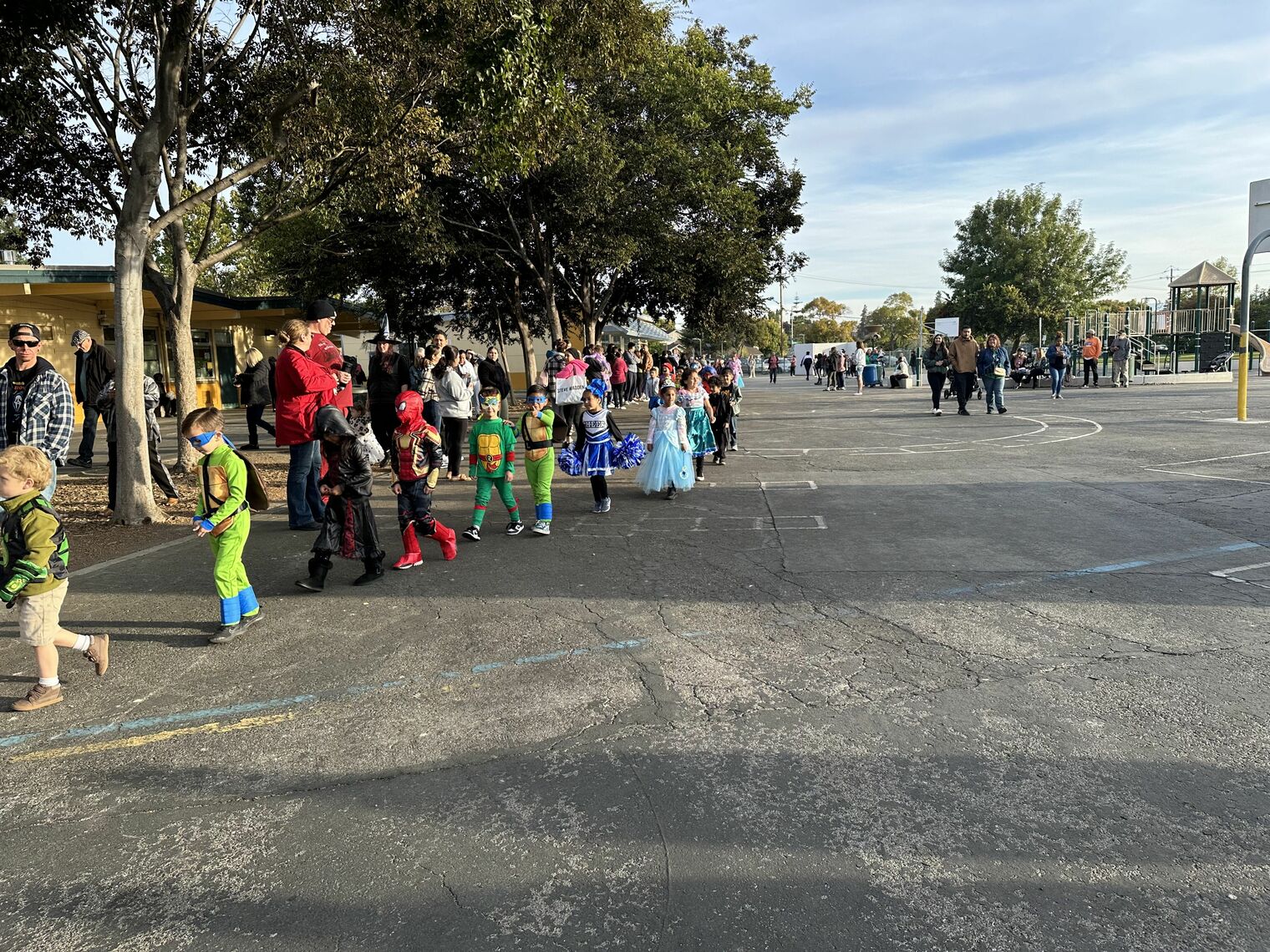 Children in costume walking on a playground