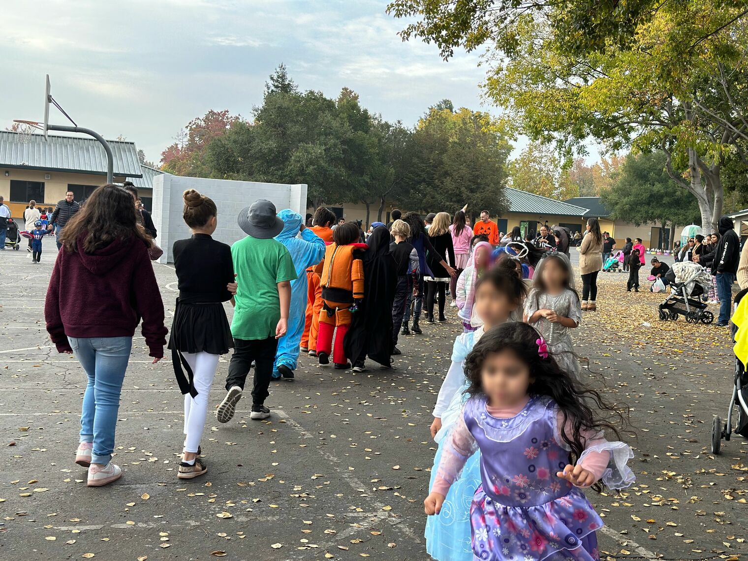 Children in costume walking on a playground