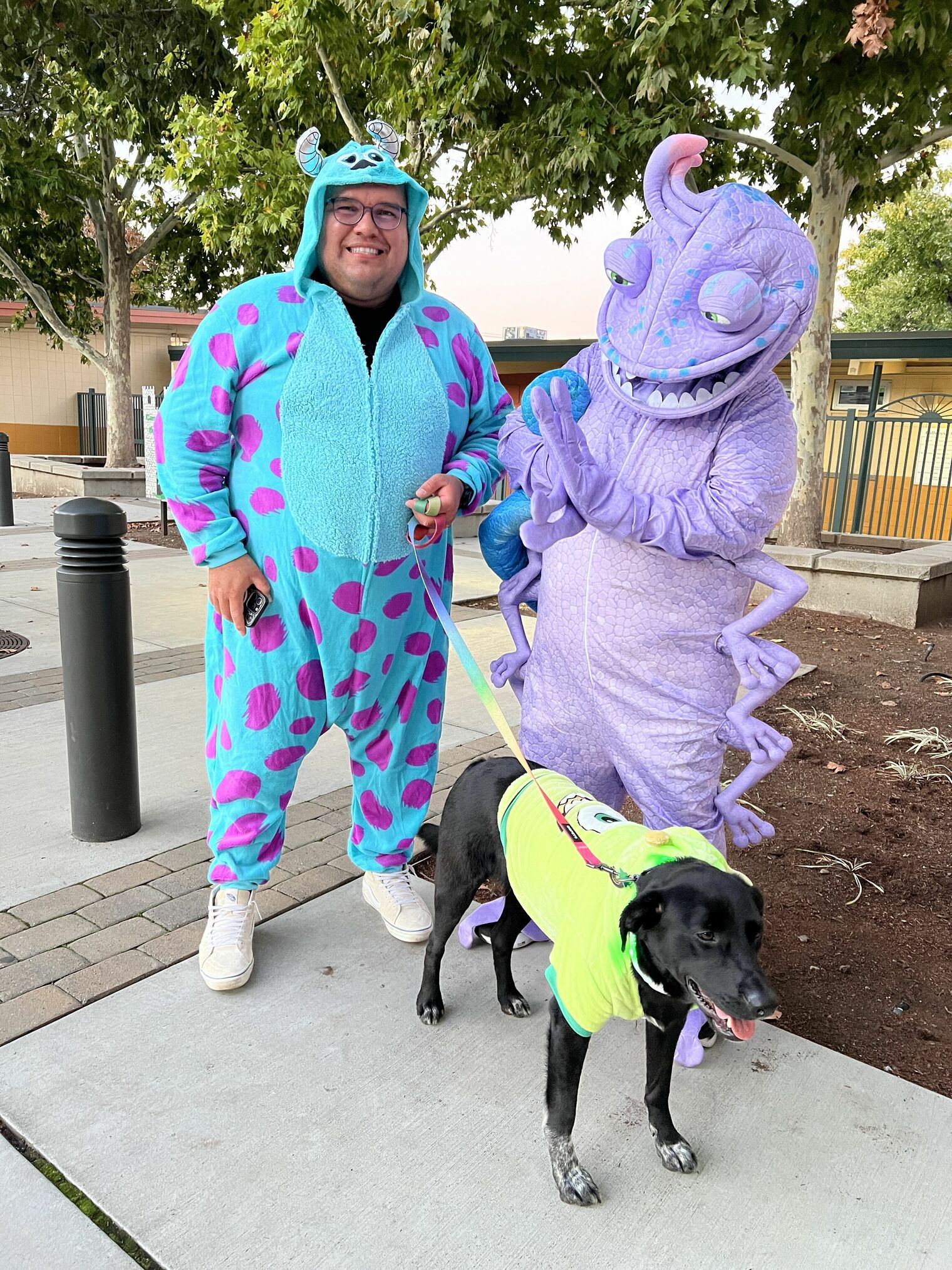 Two Monsters Inc costumed adults