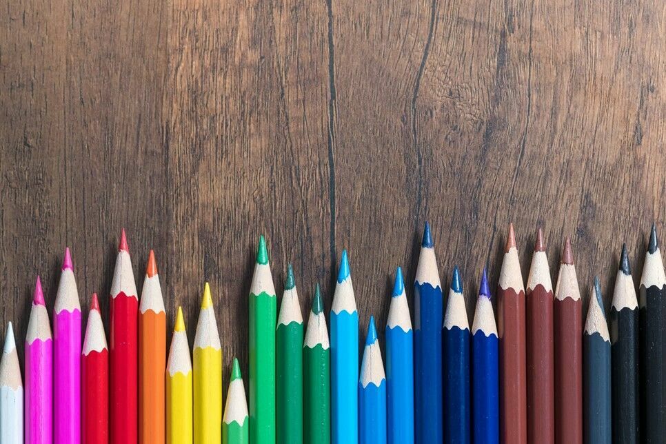 A range of colored pencils in a row.