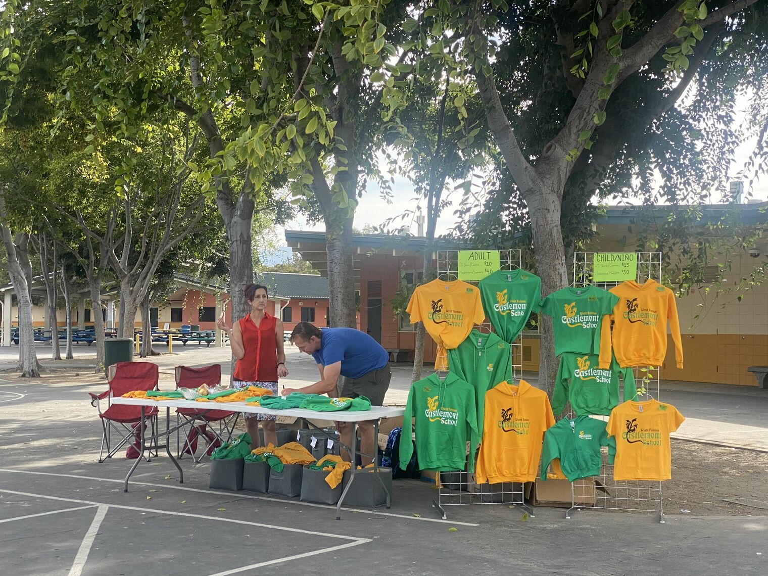 green and gold sweatshirts hanging on a display rack