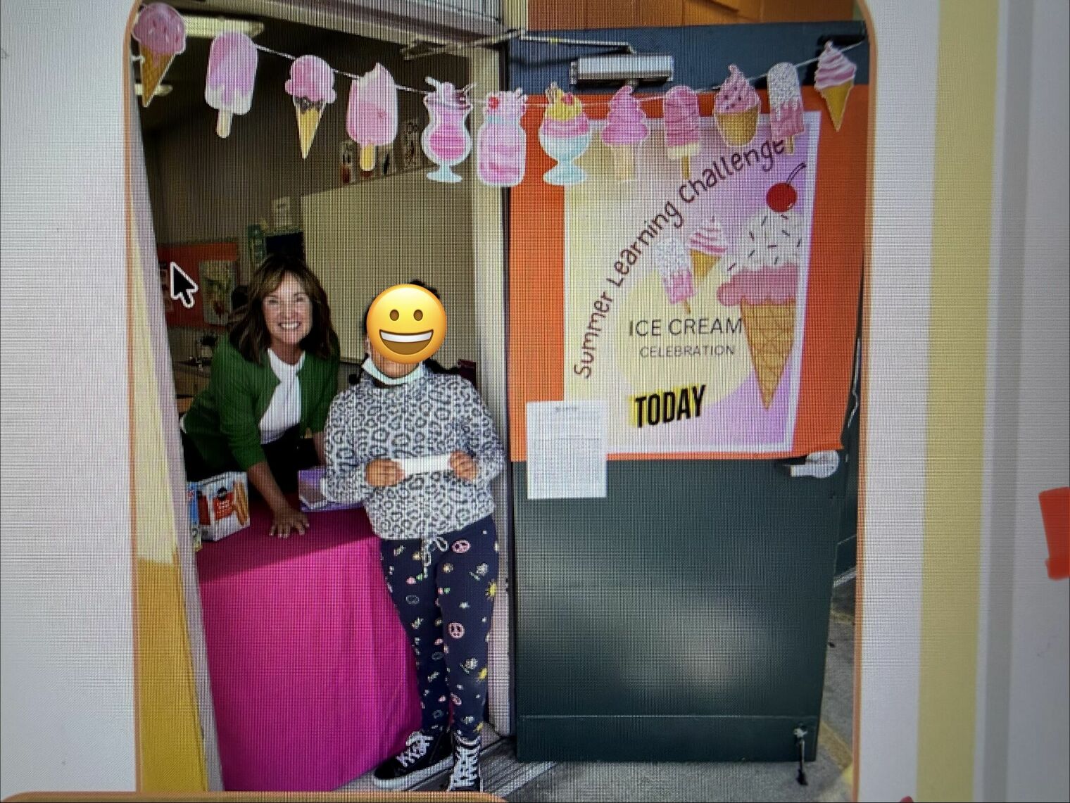 Two people in a  doorway next to an ice cream sign